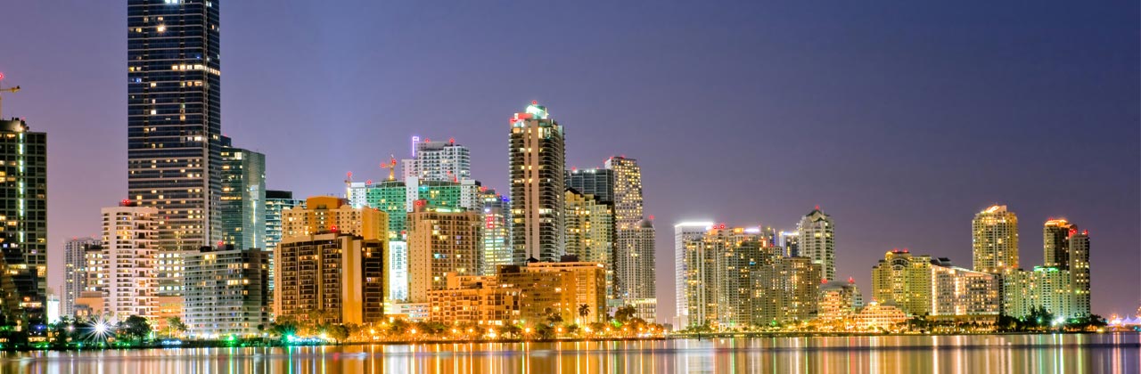 s-nmiami1-shutterstock_24087229-miami-florida-bayfront-skyline-at-dusk-with-lights-shimmering-in-water-2009