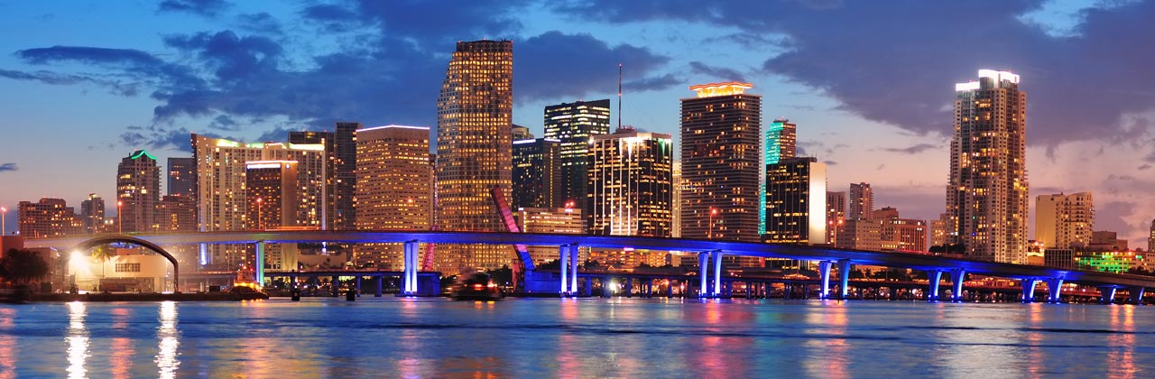 s-nmiami2-shutterstock_114080440-Miami-city-skyline-panorama-at-dusk-with-urban-skyscrapers-and-bridge-over-sea-with-reflection