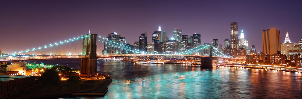 shutterstock_67770118-New-York-City-Brooklyn-Bridge-and-Manhattan-skyline-panorama-view-with-skyscrapers-over-Hudson-River-illuminated-with-lights-at-dusk-after-sunset.